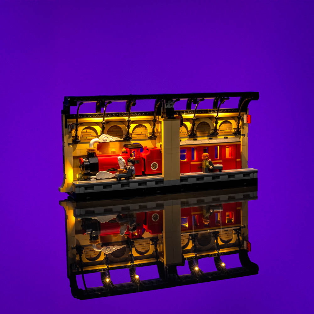 Warmly illuminated platform with the Hogwarts Express and mirrored reflection