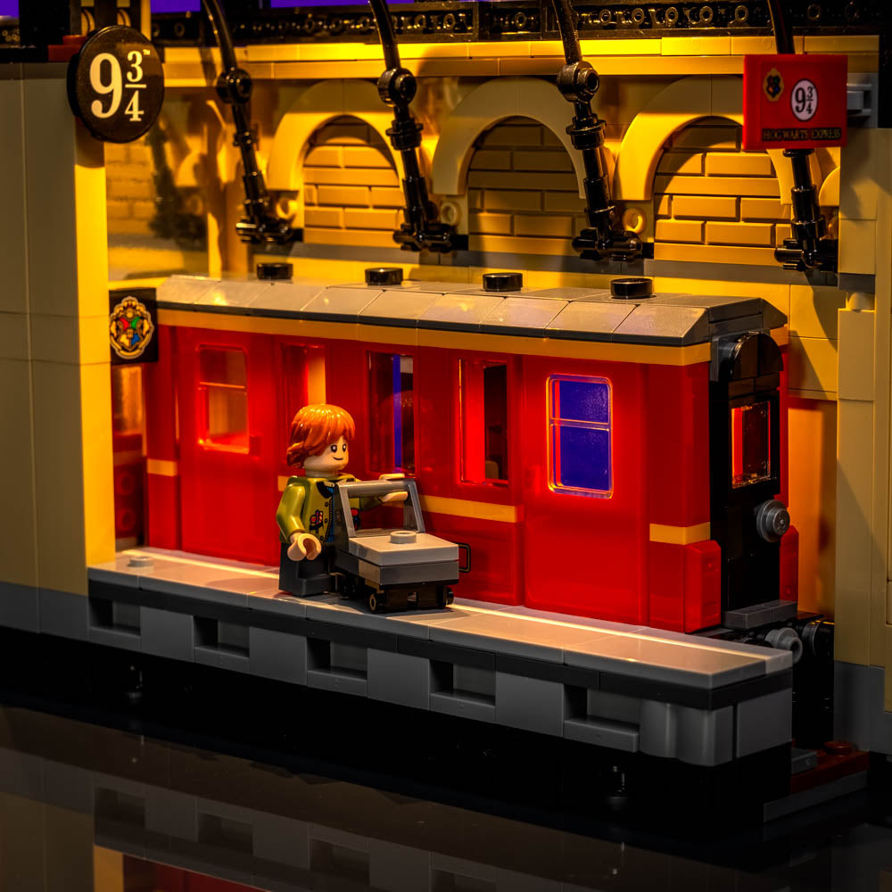 Yellow illuminated passenger carriage with Ron standing on the platform