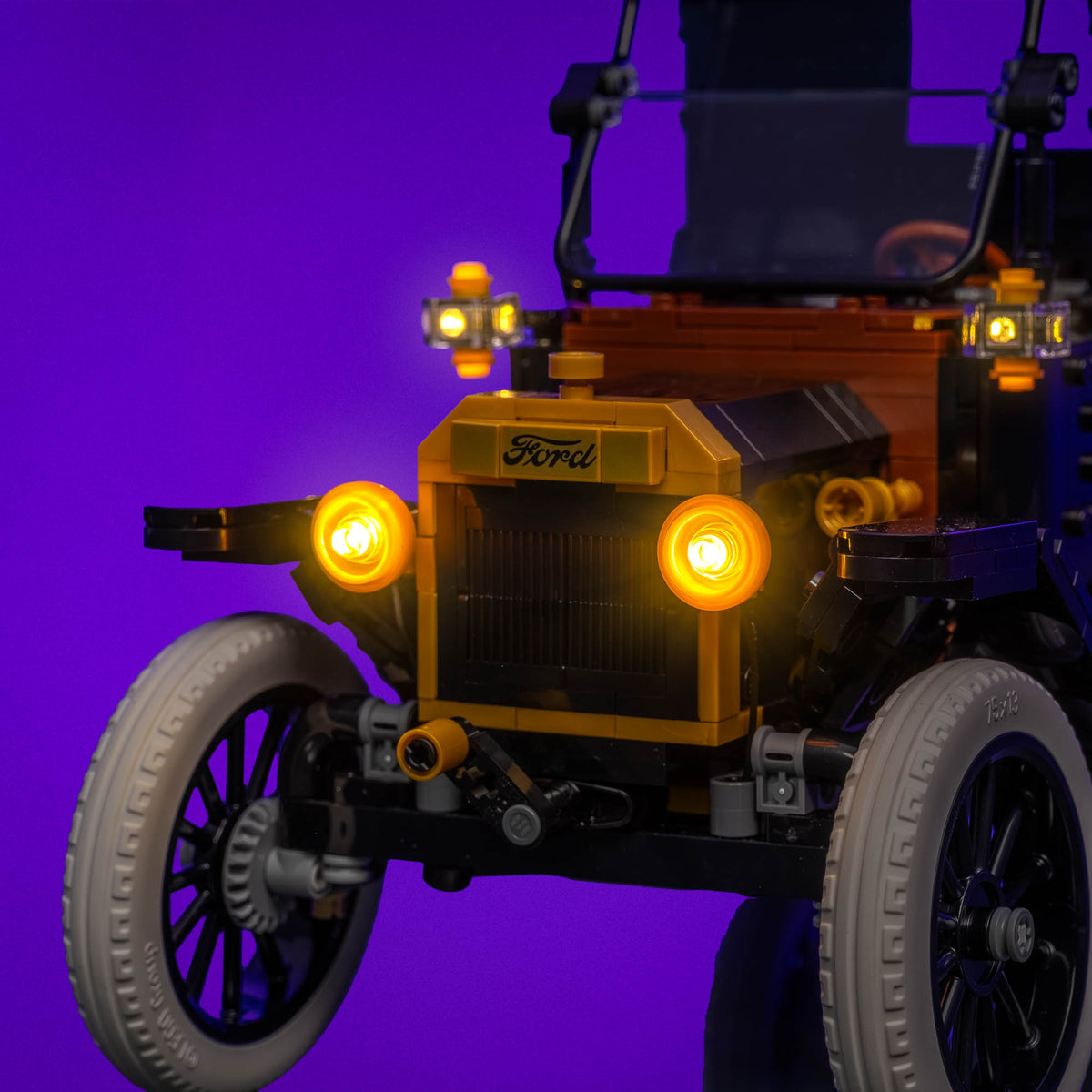 Warm white illuminated headlights of the Ford Model T