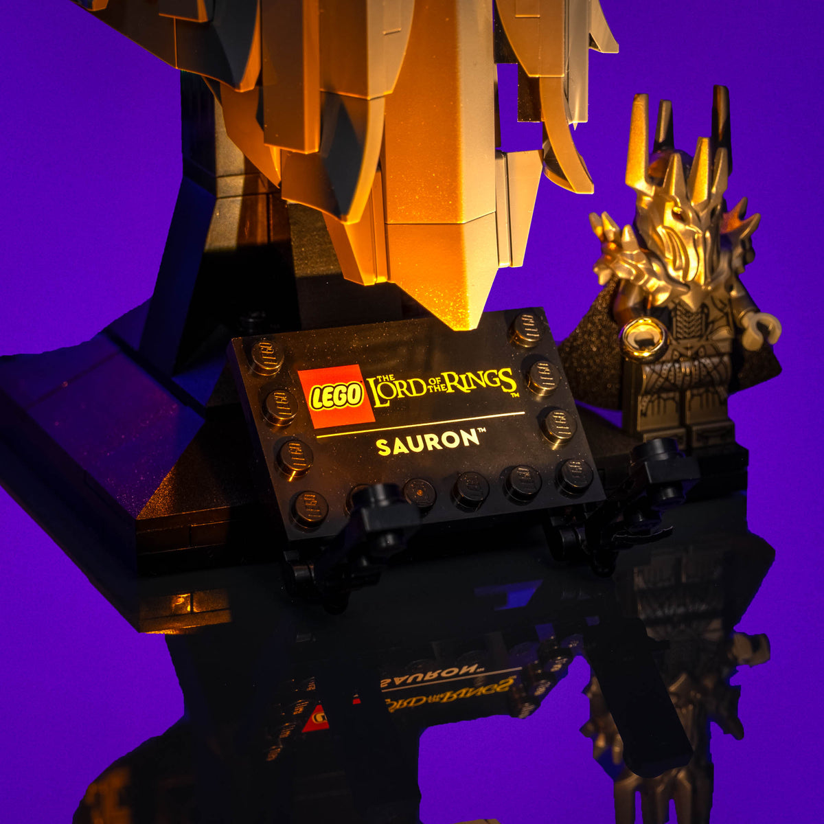 Illuminated name plaque and Sauron figure beside the helmet